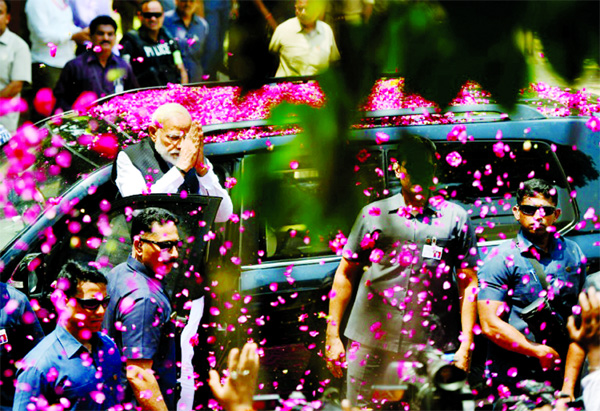Indian Prime Minister Narendra Modi is showered with petals during an election campaign.