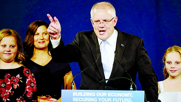 Australian Prime Minister Scott Morrison speaks to party supporters flanked by his wife and daughters. Morrison's conservative coalition won a surprise victory in the country's general election. Internet photo