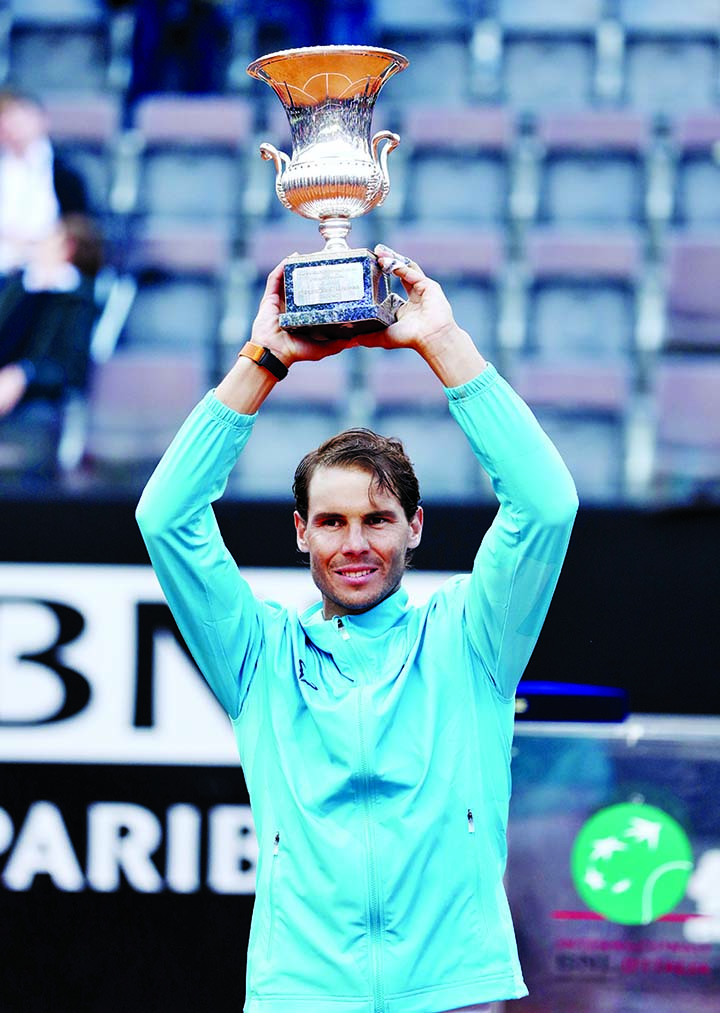 Spain's Rafael Nadal poses with the trophy as he celebrates winning the final against Serbia's Novak Djokovic in Rome, Italy on Sunday.