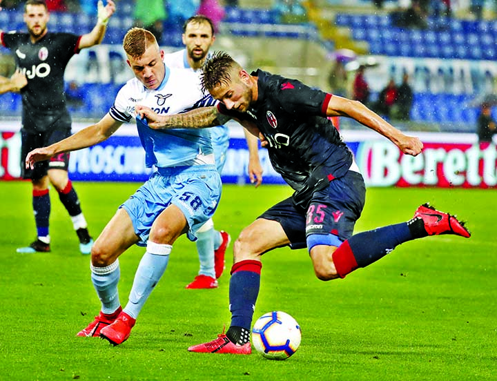 Lazio's Nicolo Armini (left) and Bologna's Mitchell Dijks vie for the ball during an Italian Serie A soccer match between Lazio and Bologna, at the Olympic stadium in Rome on Monday.