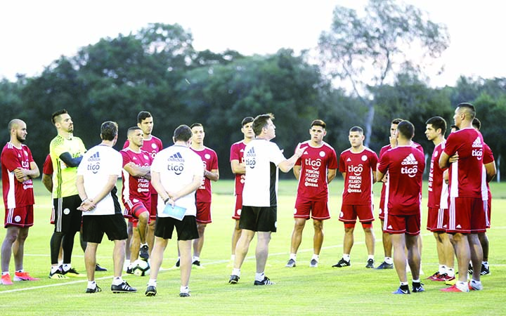 Paraguay's National Soccer team coach Eduardo Berizzo (center) talks to his players during a training session at Ypane, Paraguay on Monday. Paraguay started its training program ahead of the Copa America championship that will be played in Brazil.