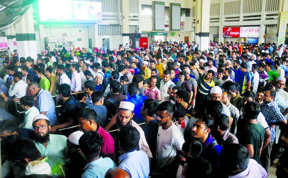 we must Go home : Thousands queue up at Kamalapur Railway Station for advance tickets on Tuesday.