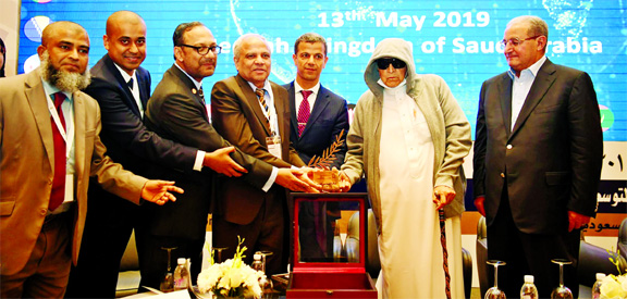 Sheikh Saleh Abdullah Kamel, Chairman of Board of Directors of Council for Islamic Banks and Financial Institutions (CIBAFI), handing over CIBAFI Award 2019 to Professor Md. Nazmul Hassan, Chairman and Md. Mahbub ul Alam, Managing Director and CEO of Isla