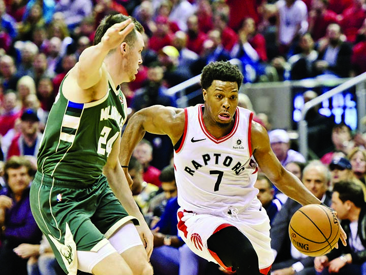 Toronto Raptors guard Kyle Lowry (7) drives for the basket as Milwaukee Bucks guard Pat Connaughton (24) defends during the second half of Game 4 of the NBA basketball playoffs Eastern Conference finals in Toronto on Tuesday.
