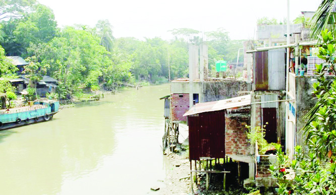 BARISHAL: Influentials building illegal constructions by grabbing Shandha River at Uzipur Upazila . This snap was taken yesterday.