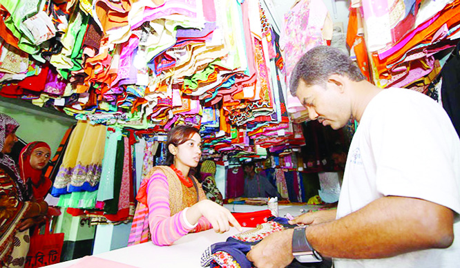 RAJSHAHI: Buyers and traders passing busy time at a shopping mall in Rajshahi yesterday.