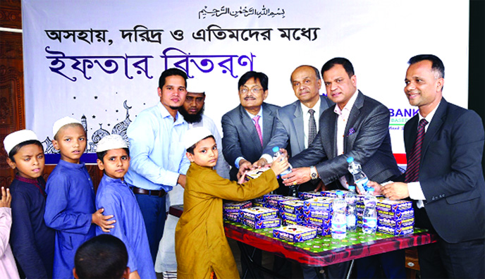 Omar Farooque, Managing Director of Union Bank Ltd, distributing Iftar among helpless, poor and orphans of different Madrasahs and Orphanages in the city recently. Adviser SM Aminur Rahman, AMD ABM Mokammel Hoque Chowdhury, DMD Hasan Iqbal, EVP and head o