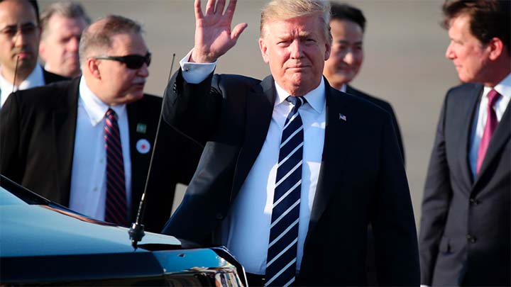 U.S. President Donald Trump waves as he arrives at the Haneda International Airport on Saturday.