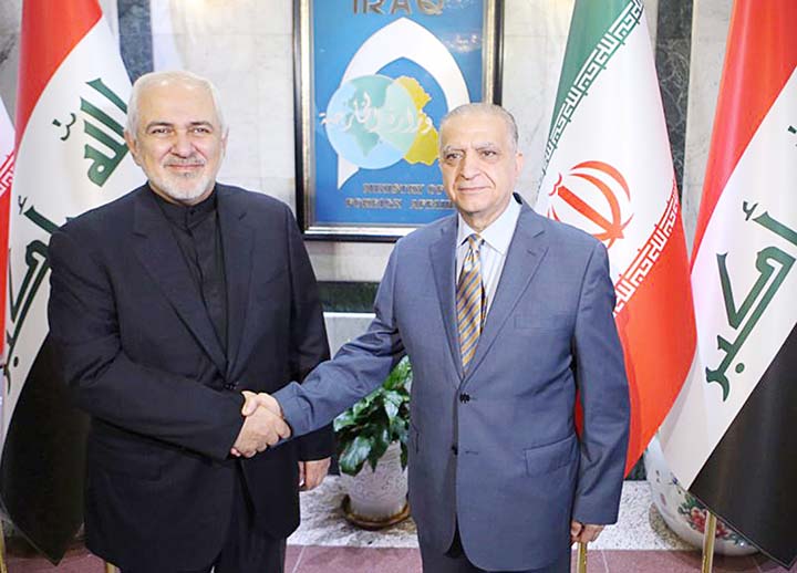 Iraqi Foreign Minister Mohamed Alhakim, (right) shakes hands with his visiting Iranian counterpart Mohammad Javad Zarif at the Ministry of Foreign Affairs Building in Baghdad, Iraq on Sunday.