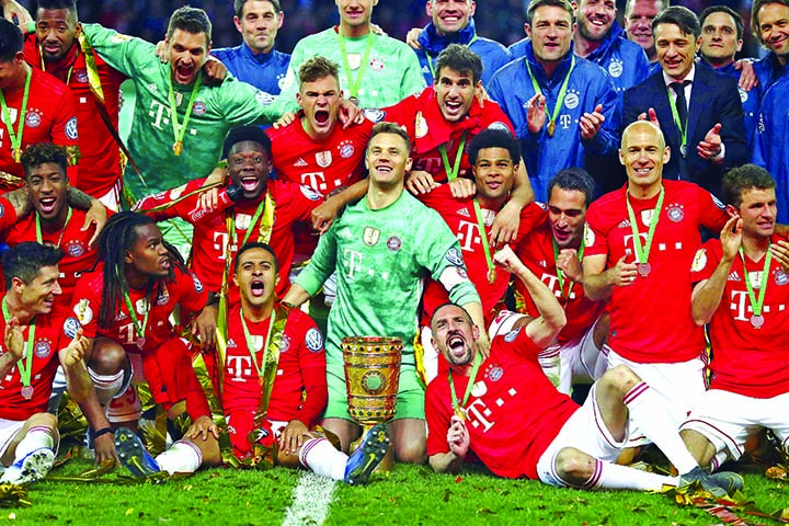 Bayern players celebrate with the trophy after winning the German soccer cup, DFB Pokal, final match between RB Leipzig and Bayern Munich at the Olympic stadium in Berlin, Germany on Saturday.