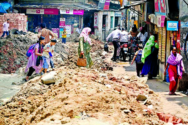 This photo exposes people's untold sufferings due to unplanned road construction work in the city's Shahjjahanpur area where mud, sand and other waste have been piled up in such a way that it is almost impossible for pedestrians to cross the area. This