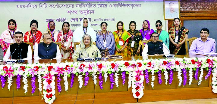 Prime Minister Sheikh Hasina poses for a photo session with the newly elected mayor and councilors of Mymensingh City Corporation at their oath taking ceremony in her office on Monday. BSS photo