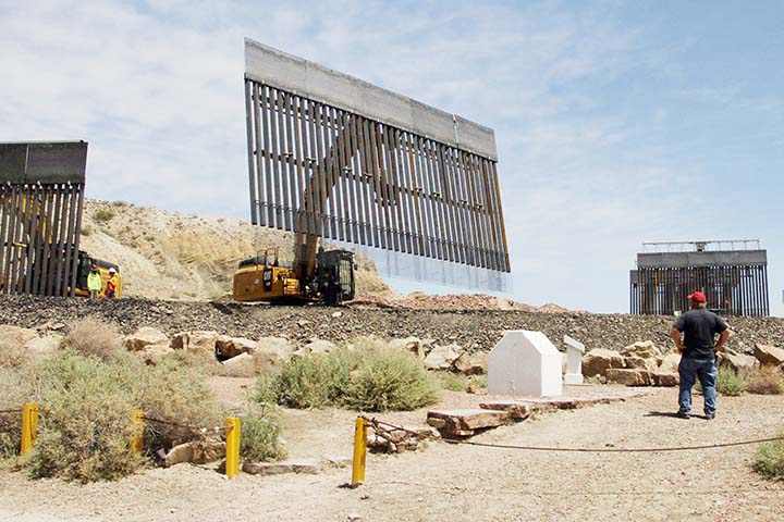 Workers build a border fence on a private property at the US-Mexico border on Sunday.