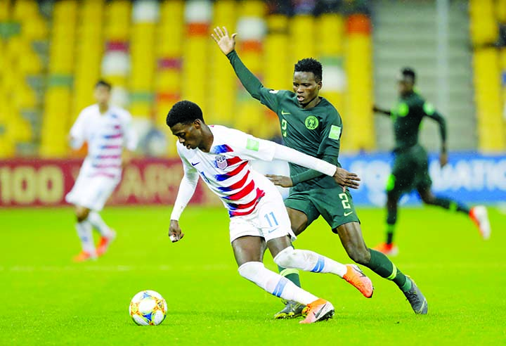 United States' Tim Weah (left) duels for the ball with Nigeria's Zulkifilu Rabiu during the Group D U20 World Cup soccer match between USA and Nigeria in Bielsko Biala, Poland on Monday.