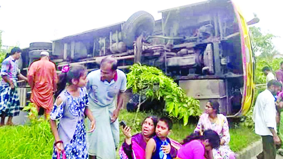 One passenger was killed and 12 others injured as a passenger bus overturned in Mirsharai upazila in Chattogram on Tuesday.