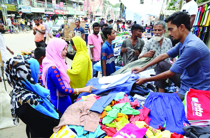 SYLHET: People rushing at footpath shops in Sylhet at Zindabazar on Tuesday.