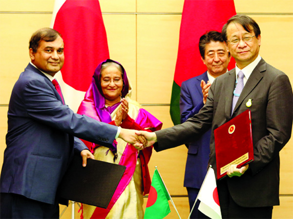 Prime Minister Sheikh Hasina and her Japanese Counterpart Shinzo Abe witnessing the signing of ODA deal with Tokyo at Abe's office in Tokyo on Wednesday.