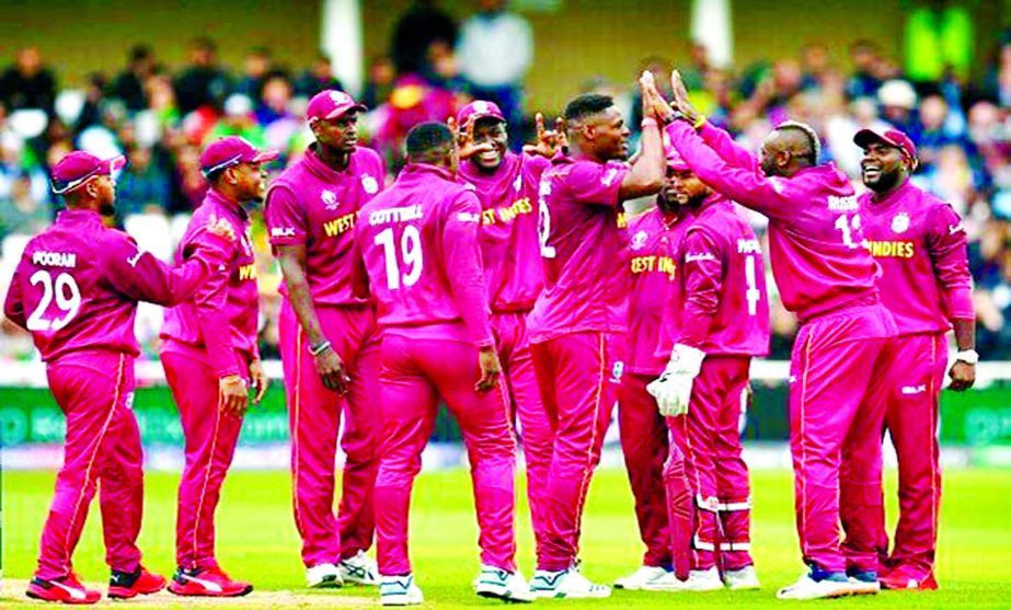 West Indies' Andre Russell (2nd from right) celebrates with his teammates after taking the wicket of Pakistan's Haris Sohail (not in the picture) in the match of the ICC World Cup Cricket between West Indies and Pakistan at Trent Bridge in Nottingham, E