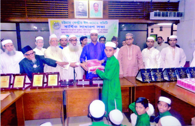 Deputy Commissioner of Chattogram Md. Elias Hossain distributing Eid clothes among the poor and orphan students in the annual meeting of Chattogram Central Eid Jamat Committee at Circuit House Auditorium on Monday