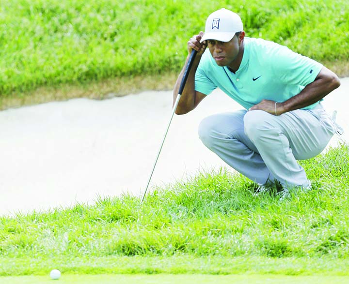 Tiger Woods lines up his putt on the 10th hole during the second round of the Memorial golf tournament in Dublin, Ohio on Friday.