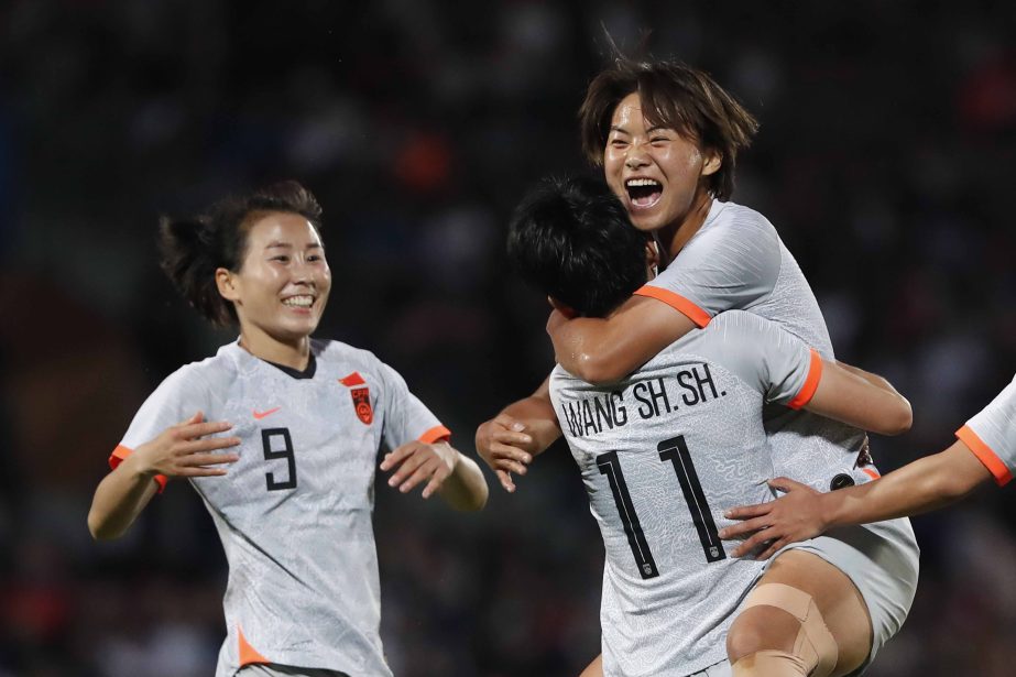 Wang Shanshan of China (right foreground) celebrates with Wang Shuang (right background) and Yang Li (left) after she scored a goal, during a friendly soccer match between France and China in Creteil, outside Paris on Friday.