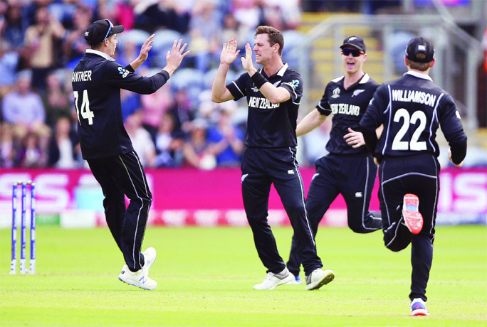 New Zealand's Matt Henry (centre) celebrates with his teammates after taking the wicket of Sri Lanka's Kusal Mendis during the ICC World Cup Cricket match between New Zealand and Sri Lanka in Cardiff, Wales on Saturday.
