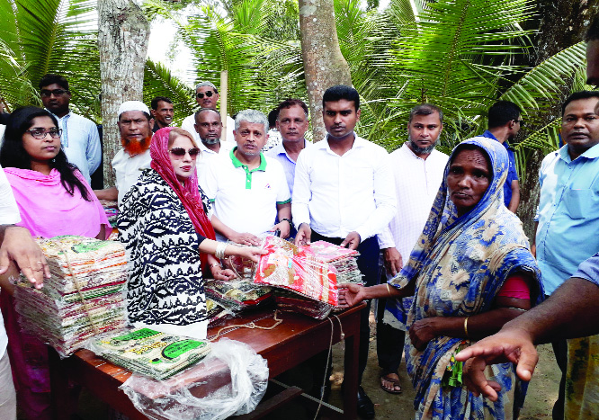 BHEDERGANJ (Shariatpur): Parvin Huq Sikder MP distributing clothes among the distress people at Bhaderganj Upazila on Saturday.