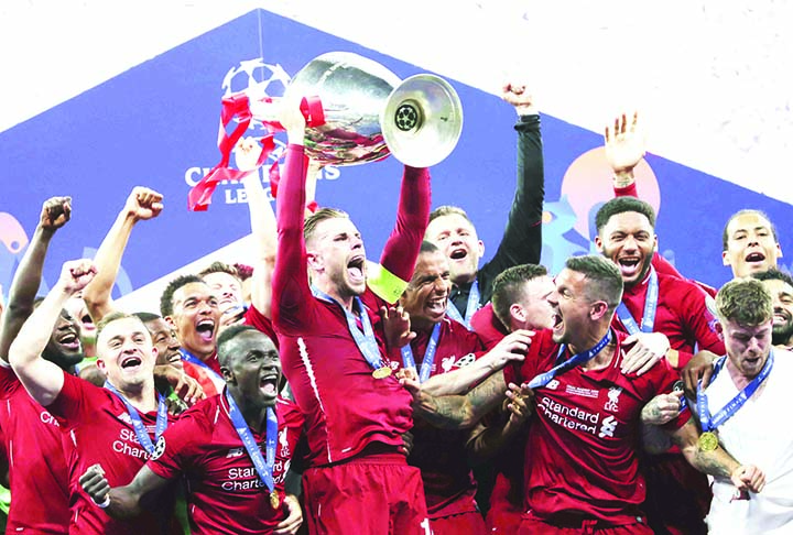 Liverpool's Jordan Henderson lifts the trophy to celebrate with his teammates winning the Champions League final soccer match between Tottenham Hotspur and Liverpool, at the Wanda Metropolitano Stadium in Madrid on Saturday.