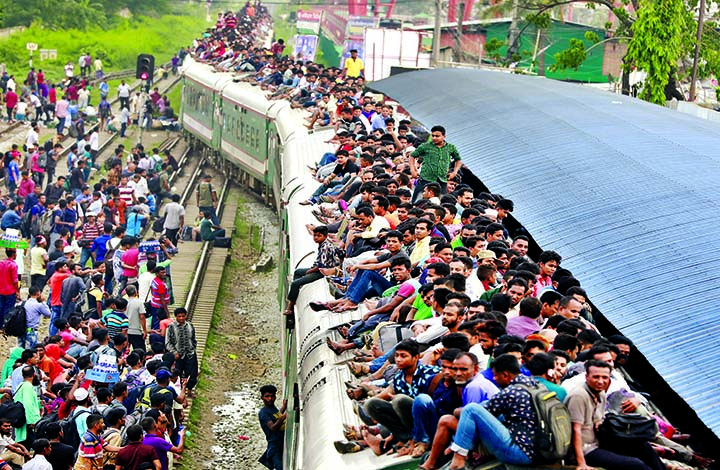 Eid holidaymakers are overcrowded on the rooftop of train departed from Kamalapur Railway Station amid delays on the 4th consecutive day of Eid travels on Monday.