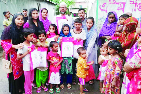 BARISHAL: Officials of Help the Poor distributed Eid items among the children in Barishal town on Eid day. s