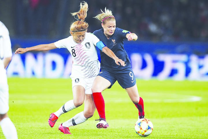 South Korea's Cho So-hyun (left) and France's Eugenie Le Sommer vie for the ball during the Group A soccer match between France and South Korea on the occasion of the Women's World Cup at the Parc des Princes in Paris on Friday.