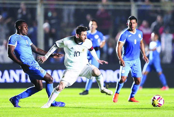 Argentina's player Lionel Messi (center) fights for the ball with Nicaragua's Luis Copete during a friendly soccer match in San Juan, Argentina on Friday.