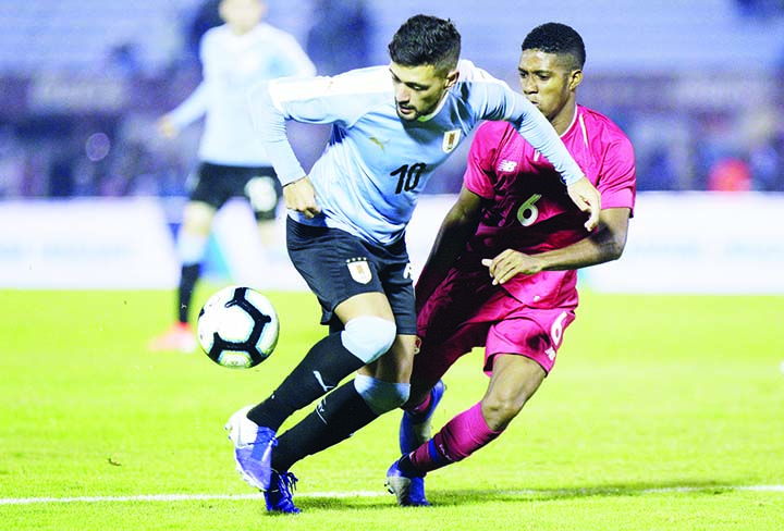 Giorgian de Arrascaeta of Uruguay (left) fights for the ball with Kevin Galvan of Panama, during a pre-Copa America friendly soccer match in Montevideo, Uruguay on Friday. Brazil will host the Copa America tournament, which runs from June 14 through July