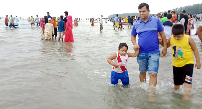 Visitors seen enjoying their Eid holidays in Cox's Bazar sea beach.