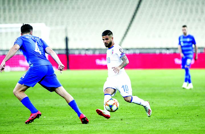 Italy's Lorenzo Insigne (center) controls the ball in front of Greece's Kostas Manolas, during the Euro 2020 group J qualifying soccer match between Greece and Italy at Olympic stadium in Athens on Saturday.