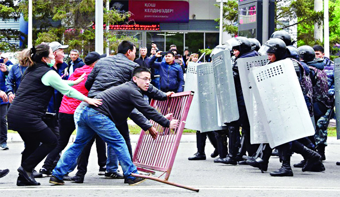 Opposition supporters confront riot police .