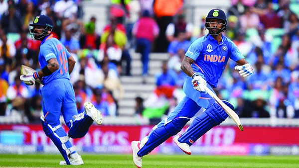 Rohit Sharma (left) and Shikhar Dhawan of India, running between wicket during the match of the ICC World Cup Cricket between India and Australia at the Oval in London on Sunday. India piled up 352 for the loss of five wickets in the stipulated 50 overs.