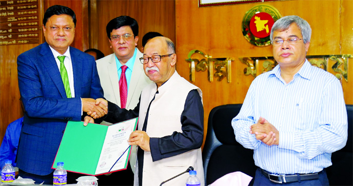 Industries Minister Nurul Majid Mahmud Humayun, MP, handing over accreditation certificate to Eng Ghulam Mohammed Alomgir, Chairman of Max Group, at a certificate giving ceremony at the minister's secretariat office on Sunday.