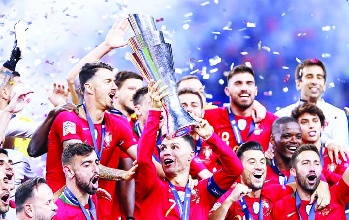 Portugal players celebrate with their trophy after defeating the Netherlands 1-0 in the UEFA Nations League final soccer match at the Dragao stadium in Porto, Portugal on Sunday.