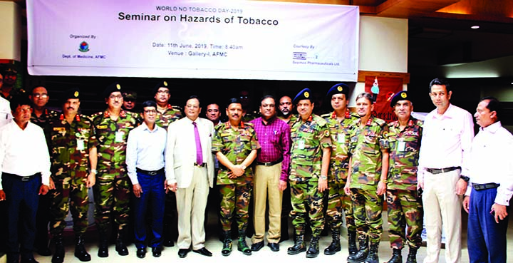 Participants in a seminar on 'Hazards of Tobacco' pose for a photo session at Armed Forces Medical College in Dhaka Cantonment on Tuesday marking World No Tobacco Day. ISPR photo