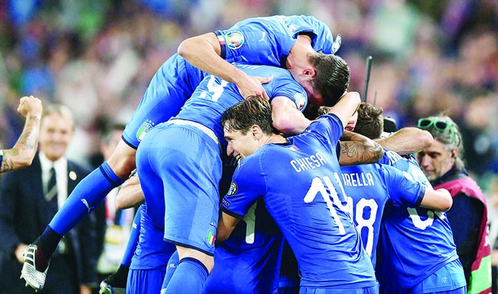 Italy's Marco Verratti is celebrated by teammates after scoring his side's second goal during the Euro 2020 group J qualifying soccer match between Italy and Bosnia- Herzegovina at the Allianz Stadium in Turin, Italy on Tuesday.
