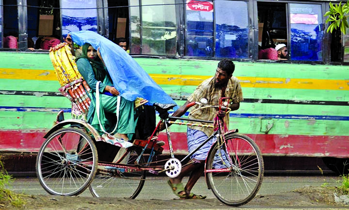 Sudden rain brings relief to city people from scorching heat though the working class people suffer much. The snap was taken from the city's Motijheel area on Thursday.