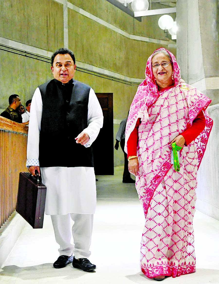 Prime Minister Sheikh Hasina along with Finance Minister AHM Mustafa Kamal entering the Sangsad Bhaban Session Room carrying the traditional suitcase to place the National Budget for fiscal 2019-20 on Thursday. PID photo