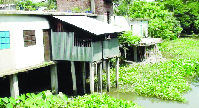 PATUAKHALI: An influential section constructing a building grabbing canal at Boro Gopaldi Bazar .