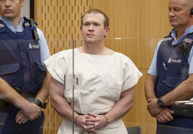 Brenton Tarrant Â©, the man charged in relation to the Christchurch massacre, stands in the dock during his appearance at the Christchurch District Court.