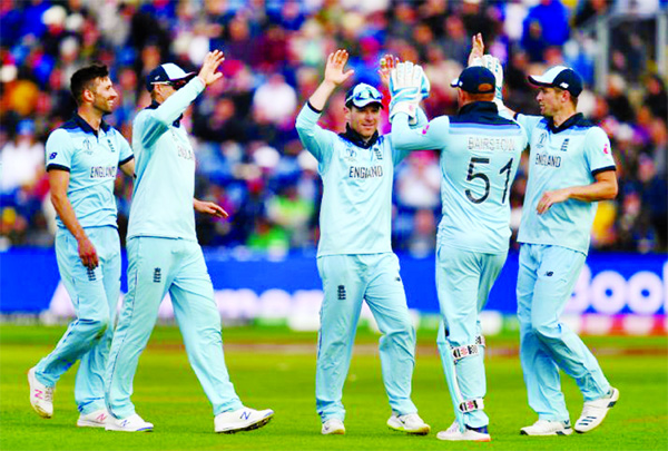 Players of England celebrate after dismissal of the wicket of Chris Gayle (not in the picture) during the match of the ICC World Cup Cricket between the hosts and West Indies at Southampton on Friday. England win the match.