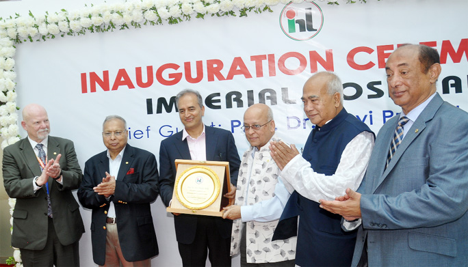 Editor of Dainik Azadi MA Malek handing over a crest to the Chairman of Narayana Health Hospital of India Dr. Devi Shetty at the inauguration ceremony of Specialized Imperial Hospital in Chattogram yesterday . Former minister and incumbent lawmaker Engr
