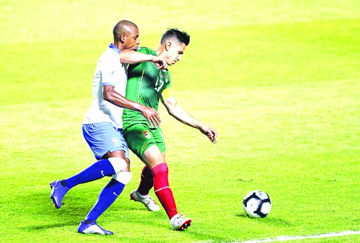 Bolivia's Marvin Bejarano (right) fights for the ball with Brazil's Fernandinho during a Copa America Group A soccer match at the Morumbi stadium in Sao Paulo, Brazil on Friday.