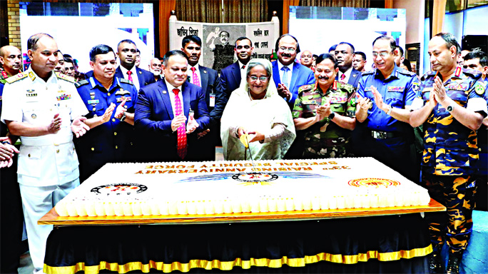 Prime Minister Sheikh Hasina cutting cake marking the 33rd founding anniversary of Special Security Force (SSF) at its Officers' Mess in city's Tejgaon area on Saturday. The Chiefs of three Services, Principal Secretary to the PM, other senior military