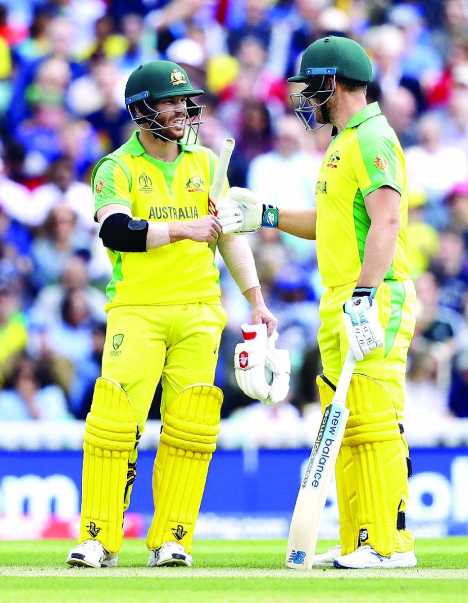 Australia's David Warner (left) and Australia's captain Aaron Finch gesture during the ICC World Cup Cricket match between Australia and Sri Lanka at the Oval in London on Saturday. Australia piled up a mammoth 334 for the loss of seven wickets in the a